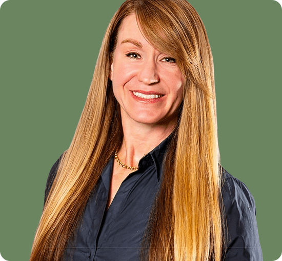 Professional woman portrait on green backdrop.