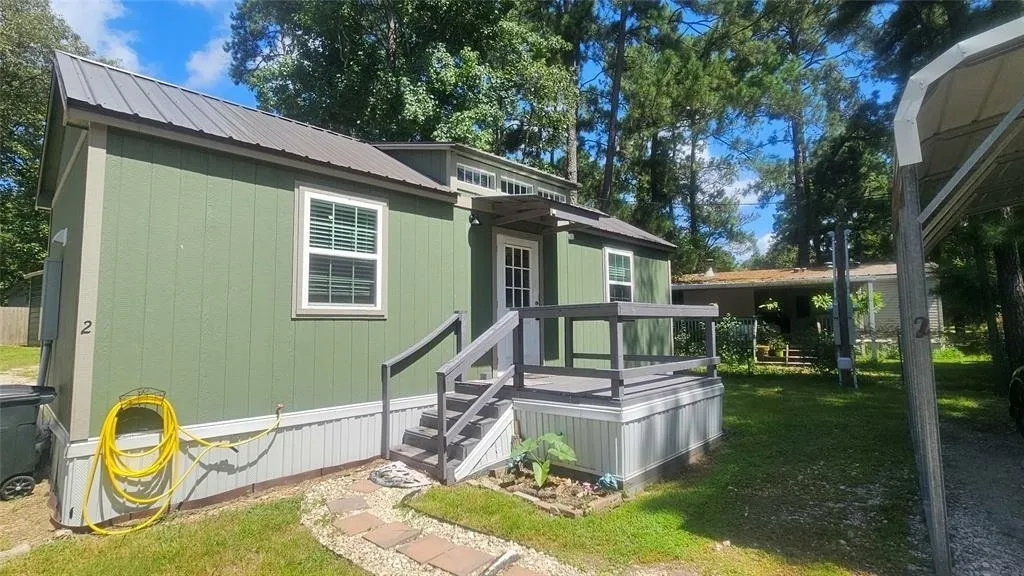 Green tiny house with front porch
